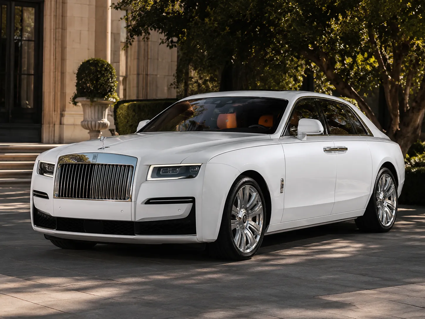 White Rolls-Royce Ghost parked outside an estate